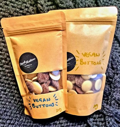 Two bags of Dark Matters vegan chocolate buttons
